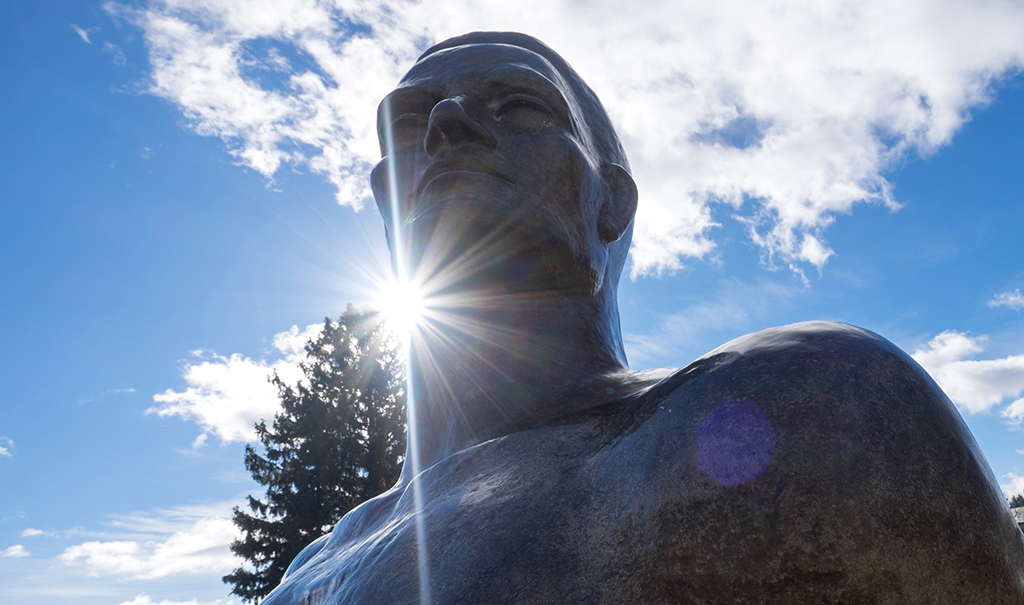 Image of Spartan statute on sunny day with blue sky