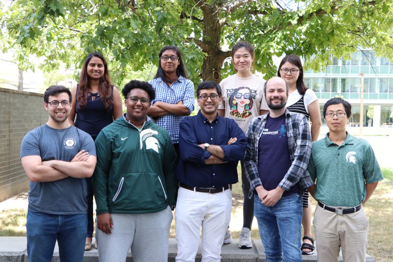 Photo of the Bhattacharya lab standing outside of the IQ building
